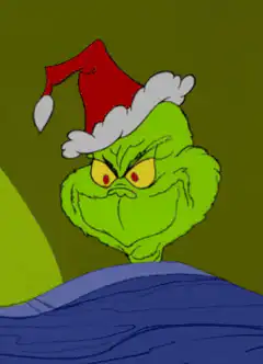 Grinch smirking in Santa hat