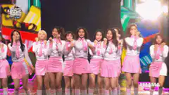 Twice performing on stage in pink outfits