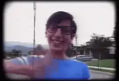 Smiling boy waving at camera