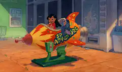 Lilo riding a rocket coin-op ride