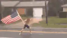 Man waving American flag in rain