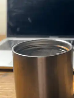 steaming metal cup on desk