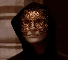 Man in black hood with golden mask