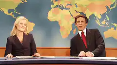Seth Meyers and Amy Poehler high five