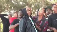 Guy with white eyes screams while crowd reacts