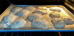Bread dough rising and baking in oven