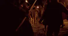 Men with torches and sticks at night