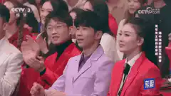 Audience clapping in red outfits