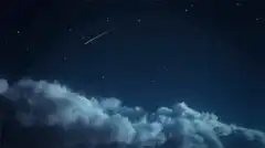 shooting star over clouds