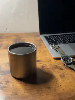 coffee cup next to laptop