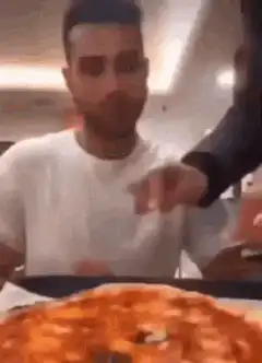 Man excitedly grabs pizza