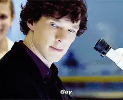 Benedict Cumberbatch as Sherlock looking at microscope