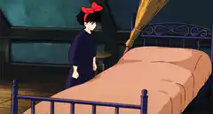 Kiki collapses onto her bed