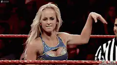 Becky Lynch waves in wrestling ring