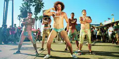Men in colorful shorts dancing outdoors