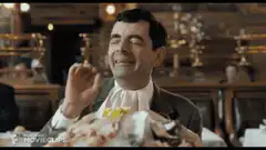 Mr. Bean eating with eyes closed