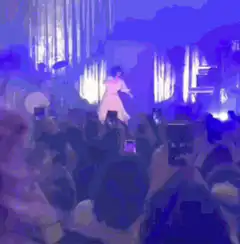 Singer in yellow dress dancing on stage