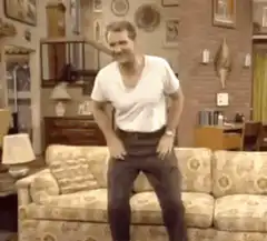 Ted Danson sitting on couch