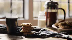 Steaming coffee and cookies on a table