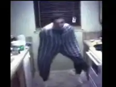 Man in oversized striped pants dancing