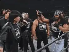 nWo members raise fists in the ring