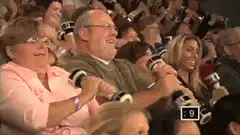Audience shaking maracas at concert