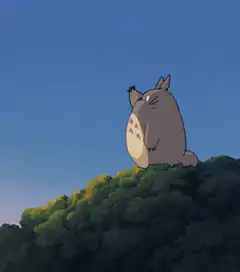 Totoro sitting on a hill