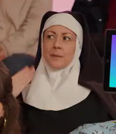 Nun looking sideways with a skeptical expression
