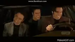 Three men laughing in a car
