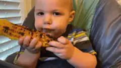 Baby eating corn on the cob