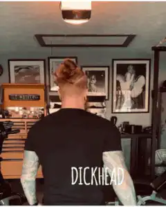 Man turns around with green dick on forehead