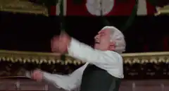 Conductor celebrating with arms raised