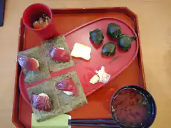 Japanese sushi and miso soup on red tray
