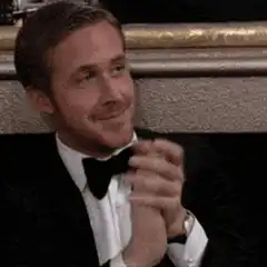 Ryan Gosling clapping and smiling