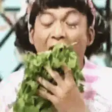 Girl eating a large bunch of celery