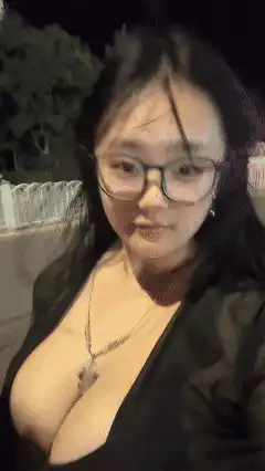 Woman in glasses posing at night