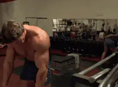 Arnold Schwarzenegger doing bent over rows