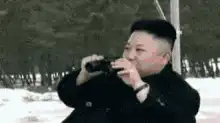 Kim Jong-un looks through binoculars at woman in towel