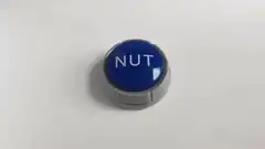 Hand hovering over blue button labeled NUT