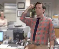 Andy Dwyer flexing in office