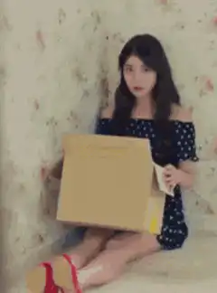 girl hiding face in cardboard box