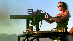 Woman firing a minigun