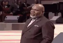 Man touches ear and looks confused