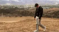 Man walking slowly in a field
