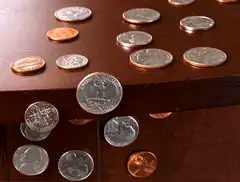 coins falling off table