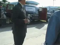 Reporter interrupted by passing car