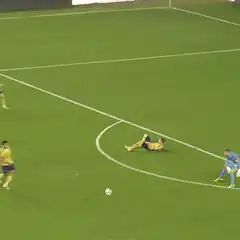 Soccer player scores past goalkeeper
