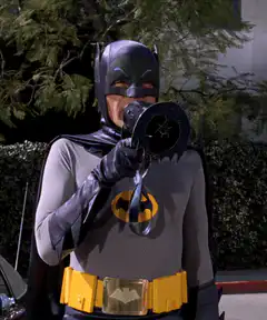 Batman drinking from a bat-shaped cup