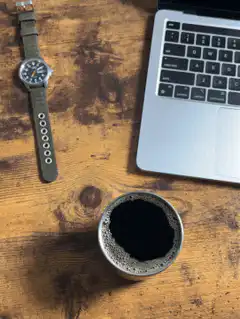 watch laptop and coffee on wooden desk