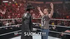 Triple H does the suck it gesture